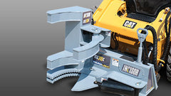 A skid steer with a Baumalight tree shear attached to it, designed for cutting down trees.
