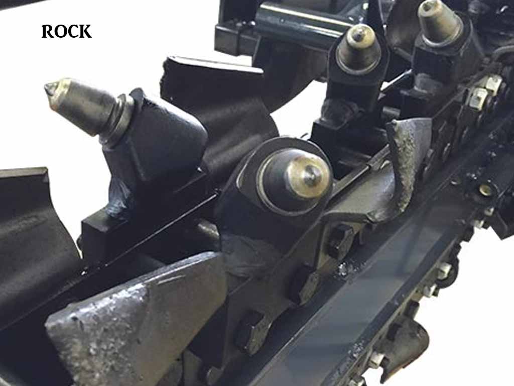 Virnig TRN v60 Trencher | Close-up of a mechanical component with 'ROCK' text on a white background