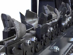 Virnig TRN v60 Trencher | Close-up of a row of metal clamps on a white background